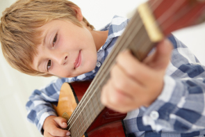 A boy playing the guitar.